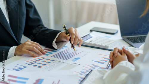 Business people present the work to the head of the department to acknowledge the company's performance, graph, chart, marketing, various financial statement in the company, quarterly result.