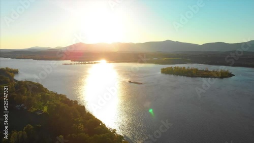 Drone shot of Hudson valley river in upstate new york with green trees and forest in a sunset 4K UHD 3840 photo