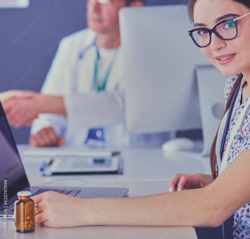 Doctor and patient discussing something while sitting at the table . Medicine and health care concept Doctor and patient discussing something while sitting at the table . Medicine and health care concept