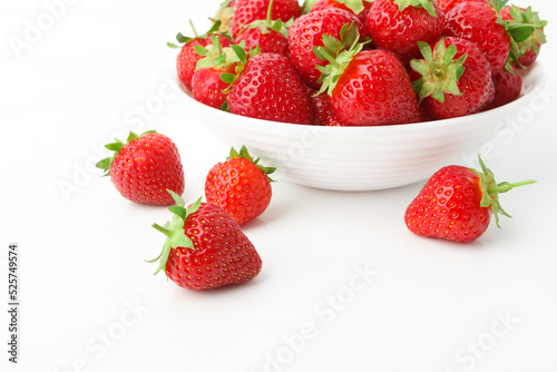 Red ripe strawberry in the white bowl