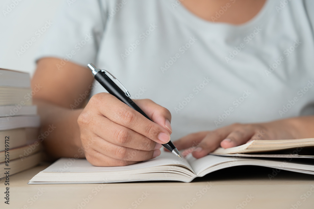 Literacy and education concept woman reading book and book stack on desk