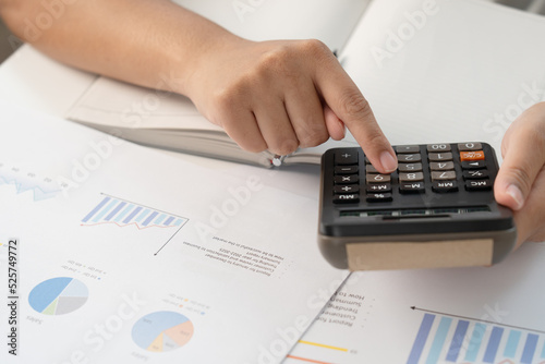 Businesswoman calculate budget with graph for business and finance data statistic project