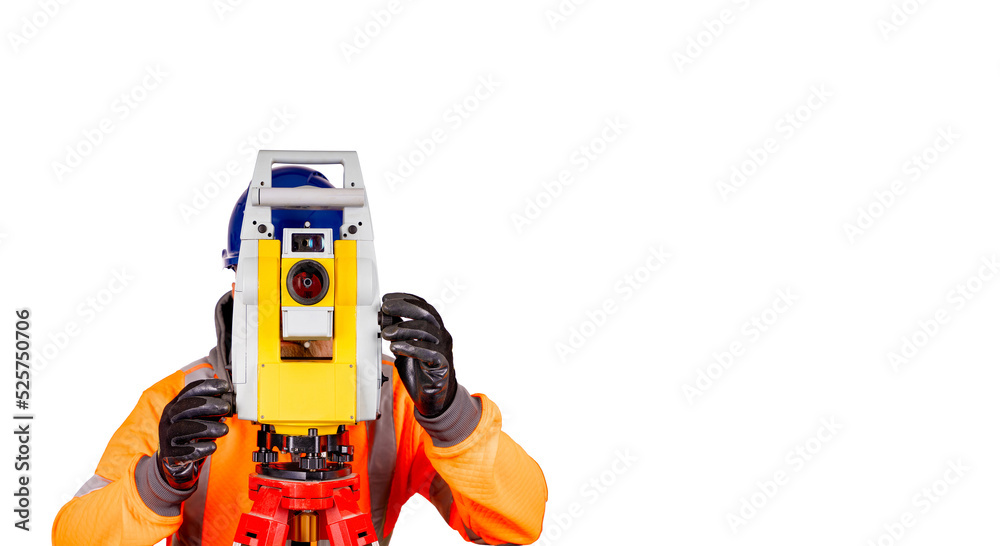 A builder in a blue helmet, orange reflective hi-visibility fleece and safety gloves on white background with space for text using modern surveying equipment.  