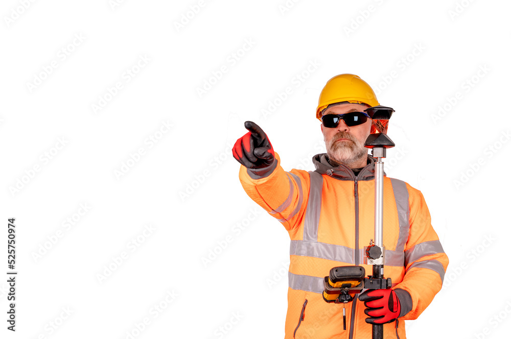 A builder in a hat and orange reflective fleece in safety glasses gives direction gesture on white background with space for text. A builder in a hat and orange reflective fleece in safety glasses gives direction gesture on white background with space for text.