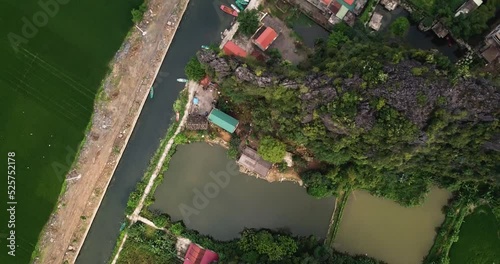 Aerial shot of houses or businesses along a canal with a reveal of small boats. photo