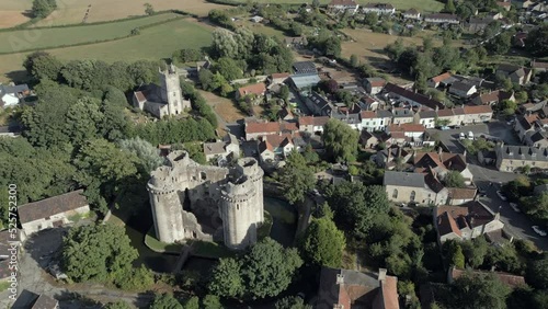 An aerial view of Nunney Castle, a medieval castle at Nunney in the English county of Somerset, England, UK. Flying right to left around the castle on a sunny, summer evening. photo