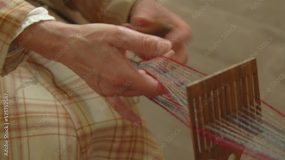 Old Scandinavian Woman Weaving Narrow Band With Yarn On Loom. - close up