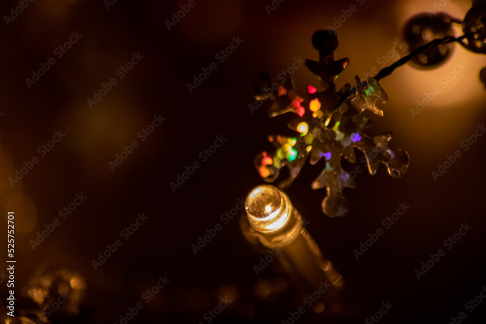 Colorful Christmas lights as multi colored chain of lights for a happy new year and holy eve as festive decoration and ornament for Christmas tree in advent time glowing bright in dark holy night