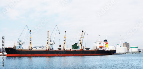 Shipping, logistics and cargo boat on ocean port in supply chain, global delivery or export industry. Travel and container ship by sea harbor of distribution, manufacturing or factory plant