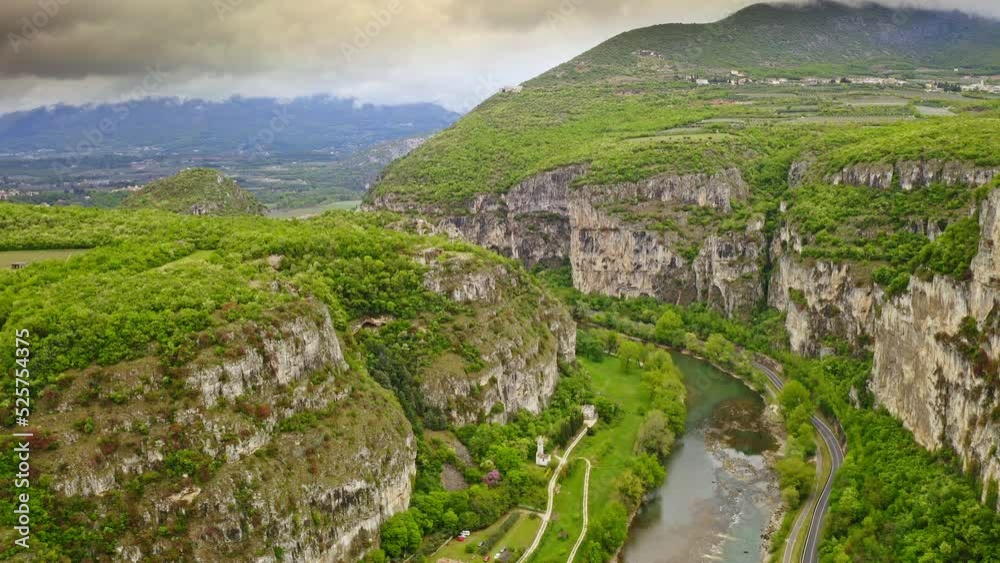 View from above slow motion mighty beautiful mountain slopes Alps wide canyon mesmerizing scenery natural landmark hilly island on famous lake garda in italy tourist destination for vacation in Europe View from above slow motion mighty beautiful mountain slopes Alps wide canyon mesmerizing scenery natural landmark hilly island on famous lake garda in italy tourist destination for vacation in Europe