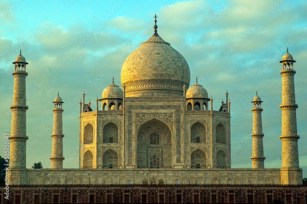 The Taj Mahal 'Crown of the Palace', is an Islamic ivory-white marble mausoleum on the right bank of the river Yamuna in the Indian city of Agra. It was commissioned in 1632 by the emperor Shahjahan.