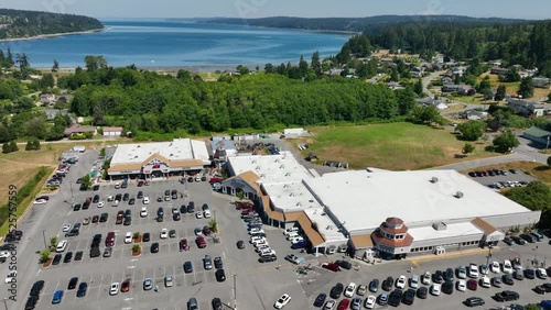 Aerial of a shopping outlet in Freeland, Washington with the Pacific Ocean off in the distance. photo