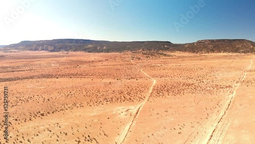 Top angle aerial view desert New Mexico Drone shot of western sand dunes and mountains with blue clear cloudless sky and brush steppe 4K UHD 3840