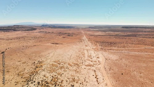 Top angle aerial view desert New Mexico Drone shot of western sand dunes and mountains with blue clear cloudless sky and brush steppe 4K UHD 3840