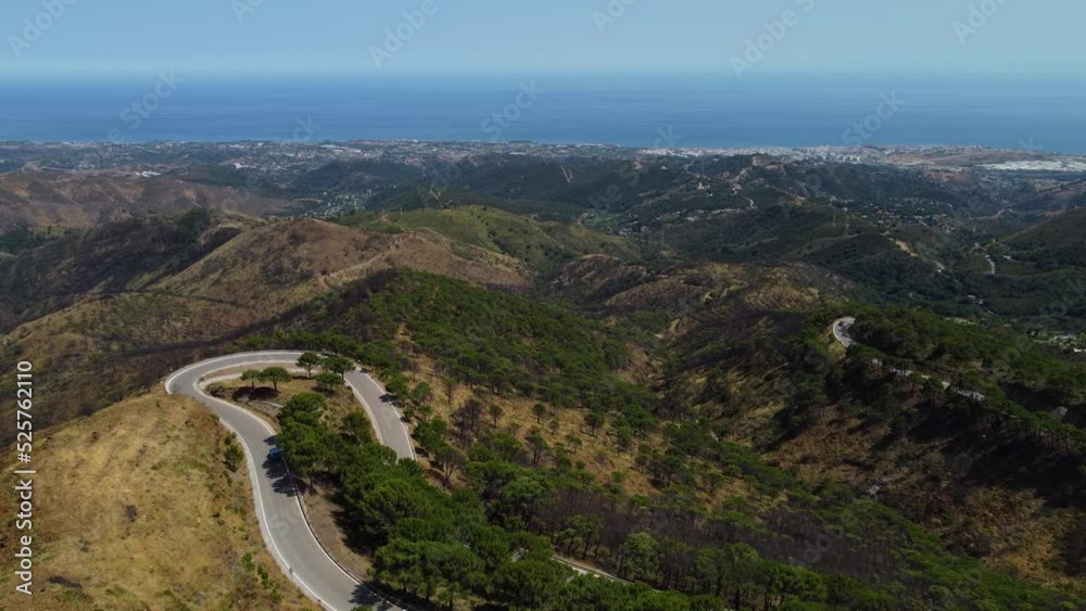 Car driving down winding road in Estepona mountain, Spain. Aerial view Car driving down winding road in Estepona mountain, Spain. Aerial view