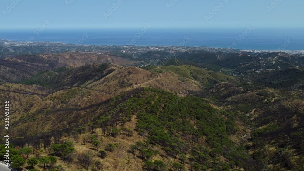 Vibrant view of Estepona hills in Spain with blue ocean in horizon, aerial view Vibrant view of Estepona hills in Spain with blue ocean in horizon, aerial view