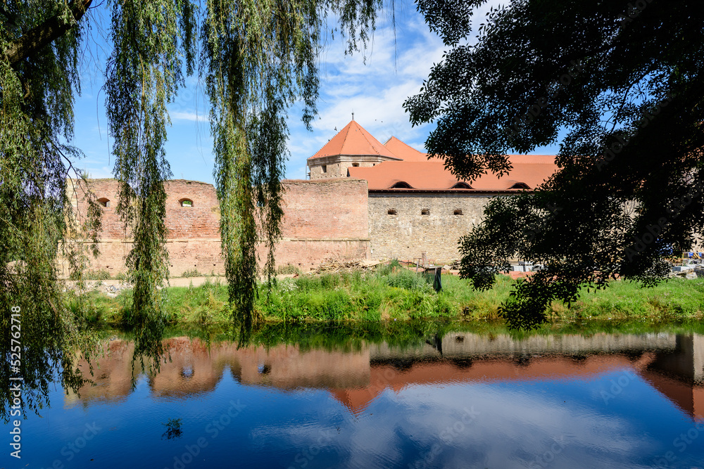 Renovated old historical buildings  of Fagaras Fortress (Cetatea Fagaras) during renovation works in a sunny summer day, in Transylvania (Transilvania) region, Romania  .