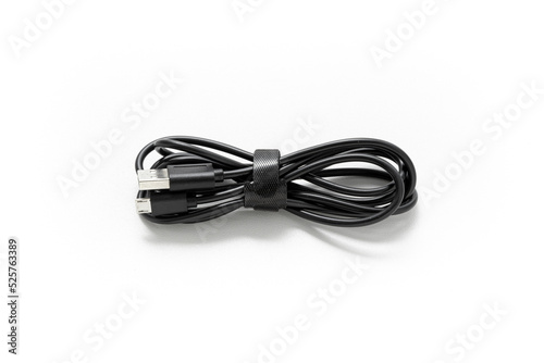 Charging cable isolated on white background. Electronic. Phone charger. Black cable. Equipment. Technology. Plug. Accessory.