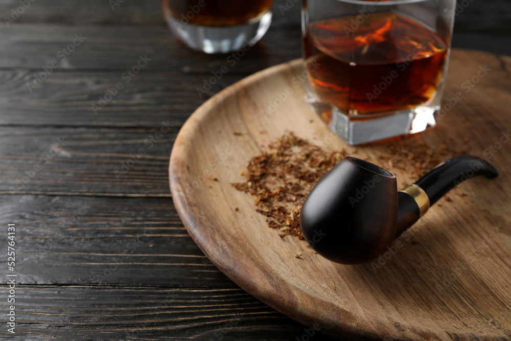 Composition of relaxation with smoking tobacco with smoking pipe, on wooden table Composition of relaxation with smoking tobacco with smoking pipe, on wooden table