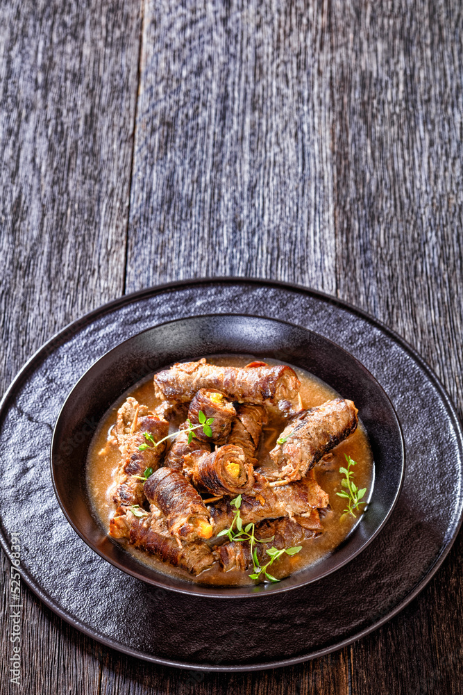 german beef rouladen in thick gravy in bowl