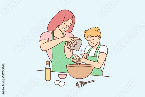 Happy mother and daughter cooking together 