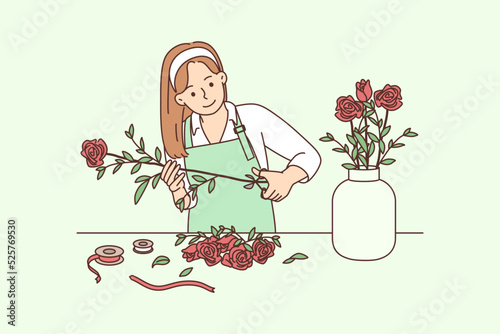 Female florist working with flowers in workshop 
