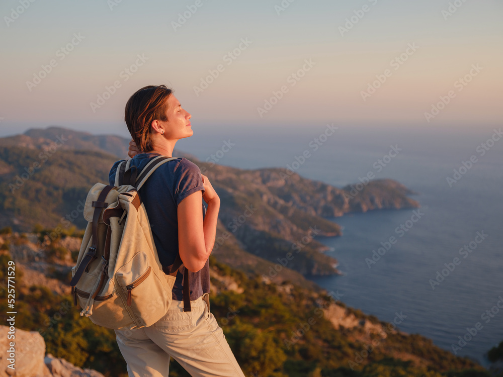 Travel to Turkey, viewpoint over Dalyan Iztuzu Beach. . Smiling woman taking break on hiking trip looking at view at sunset. Explore natural wonders of Turkey Travel to Turkey, viewpoint over Dalyan Iztuzu Beach. . Smiling woman taking break on hiking trip looking at view at sunset. Explore natural wonders of Turkey
