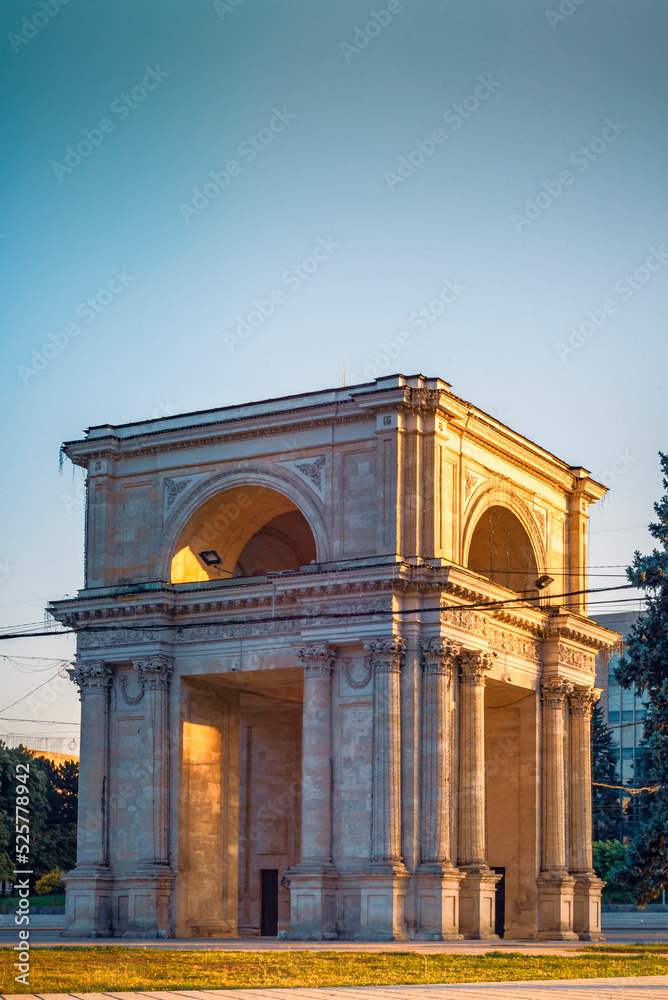 Fototapeta premium CHISINAU, MOLDOVA - august 20, 2022: Triumphal Arch sunset beautiful light monument national square Victory European Capital center city long exposure.
