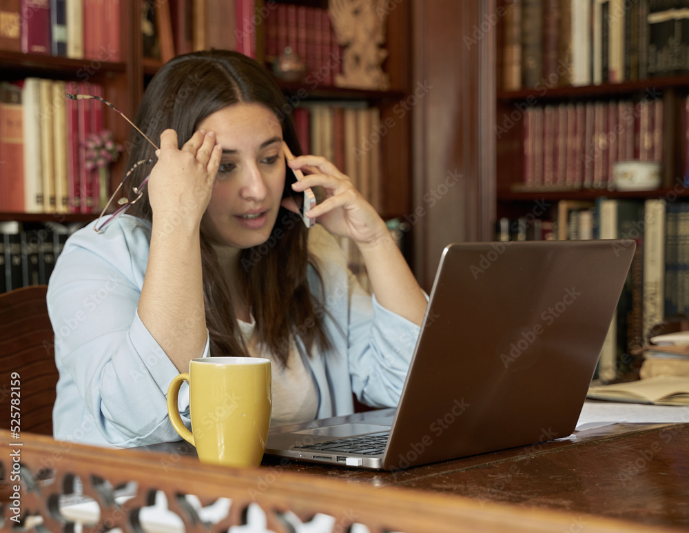 Writer resting and smiling while looking at her mobile phone and reading her novel. Writer resting and smiling while looking at her mobile phone and reading her novel.