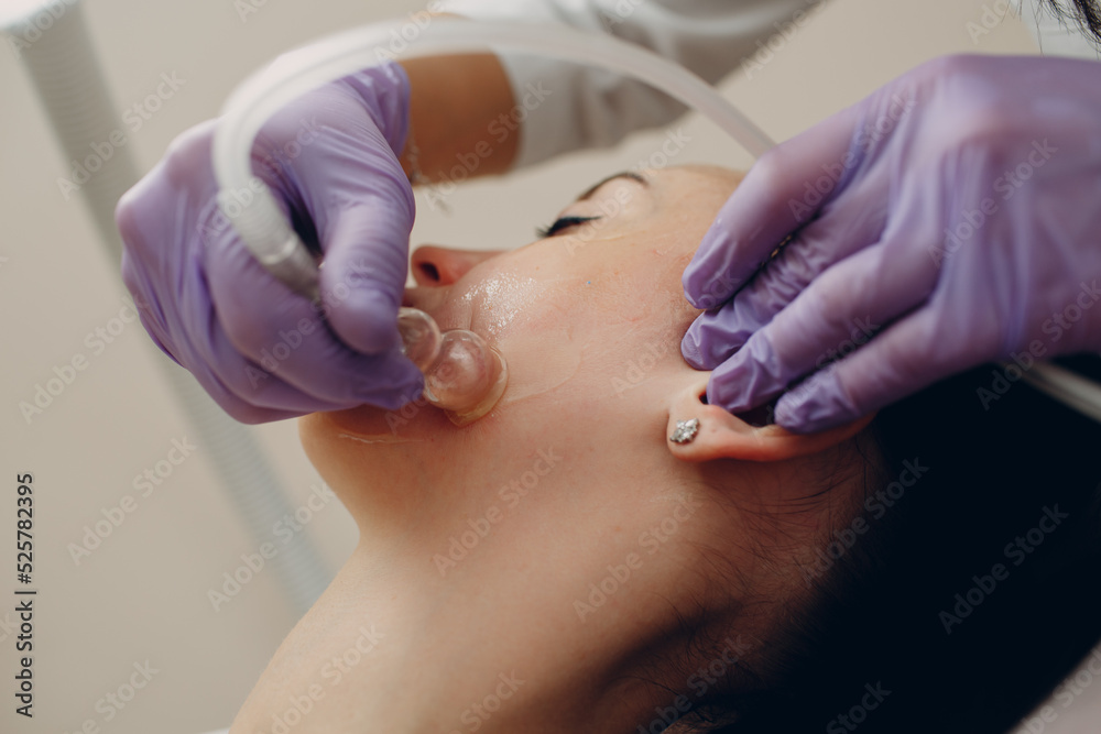 Woman Getting Vacuum Cleaning Face Treatment At Beauty Clinic Woman Getting Vacuum Cleaning Face Treatment At Beauty Clinic
