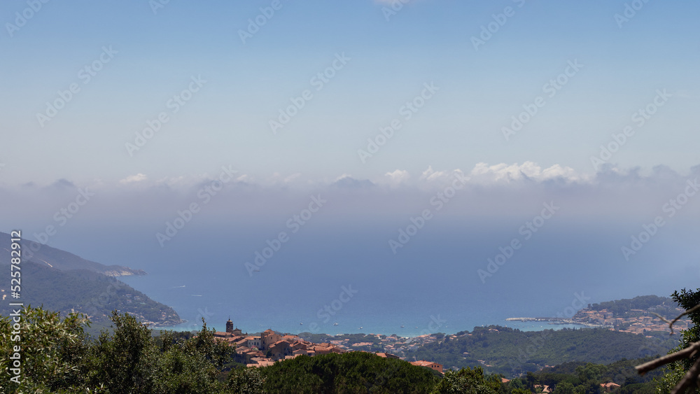 Fototapeta premium Little Medieval village Sant'Ilario on the quiet hill in the middle of the Monte Perone, with a breathtaking view of the gulf of Marina di Campo. Island of Elba, Italy