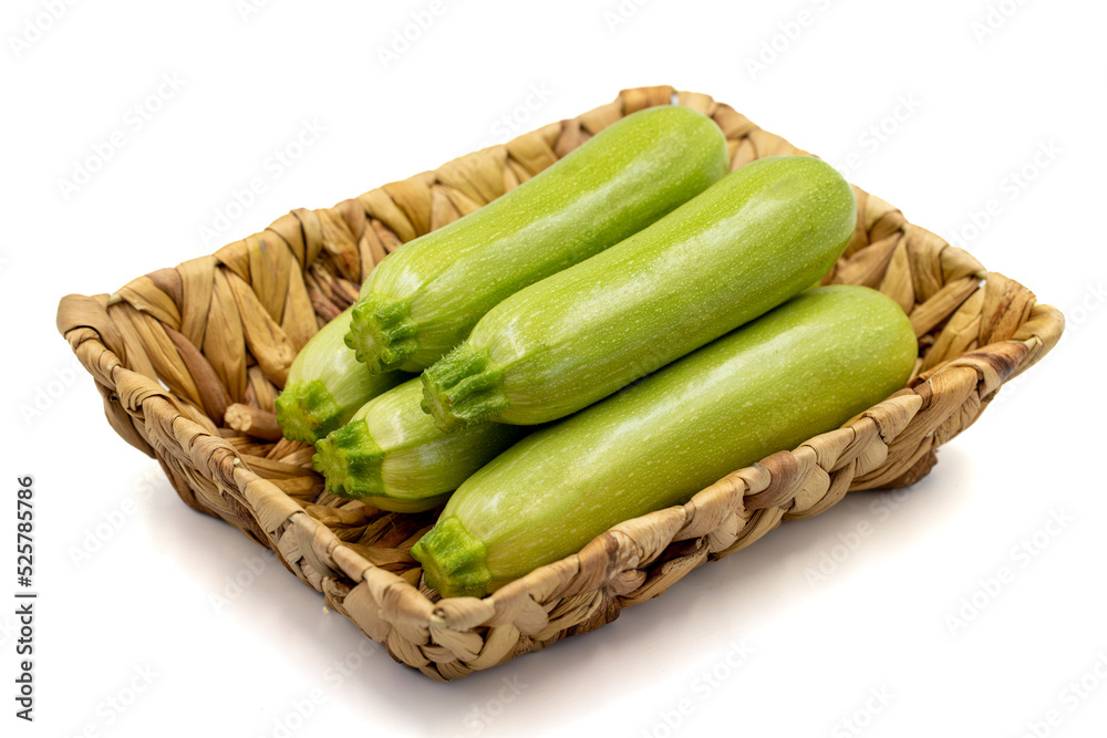 Organic zucchini. Fresh zucchini in basket isolated on white background. Vegetable, healthy vegan food. close up Organic zucchini. Fresh zucchini in basket isolated on white background. Vegetable, healthy vegan food. close up