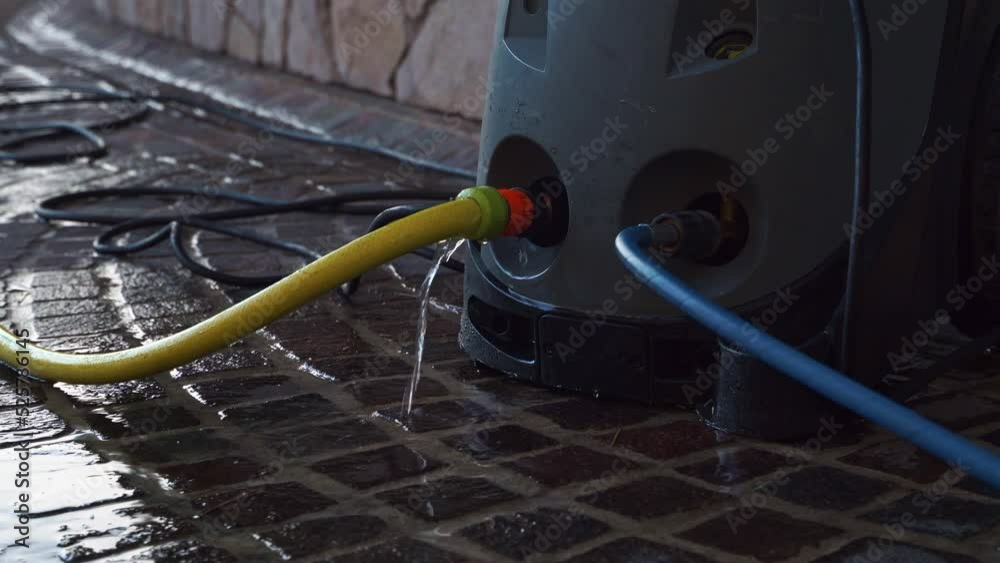 The yellow water hose leaks at the connection point to the High