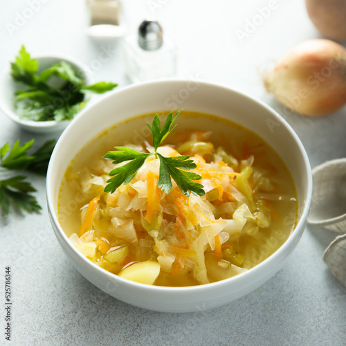 Traditional homemade sauerkraut soup with fresh parsley