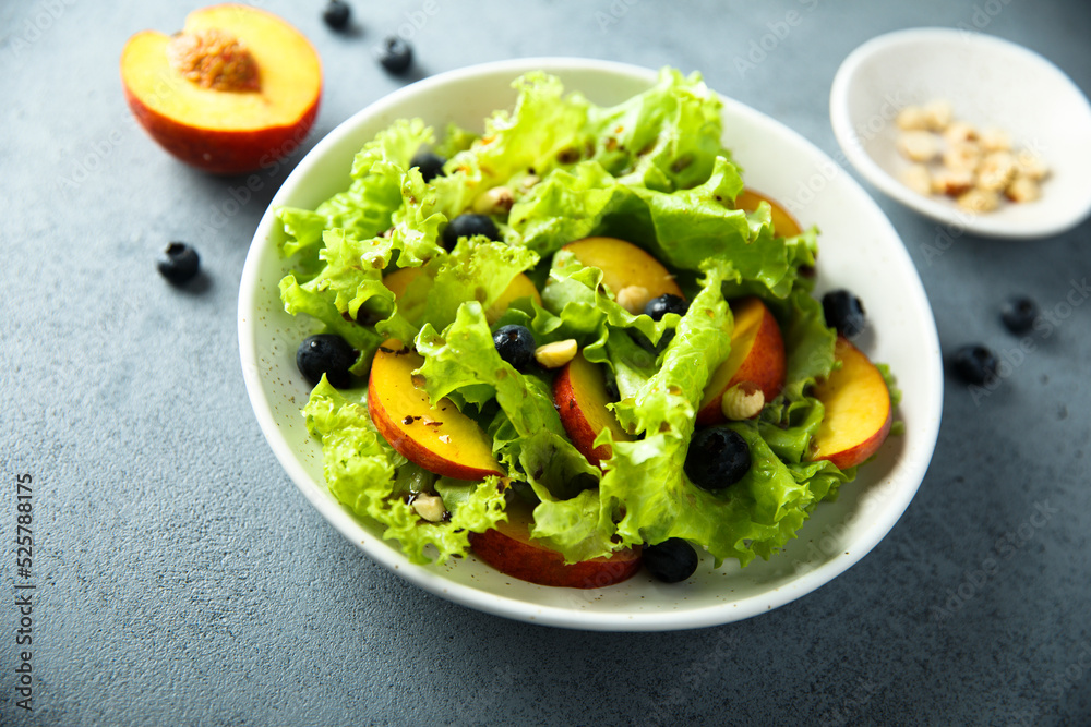 Healthy leaf salad with peach and blueberry