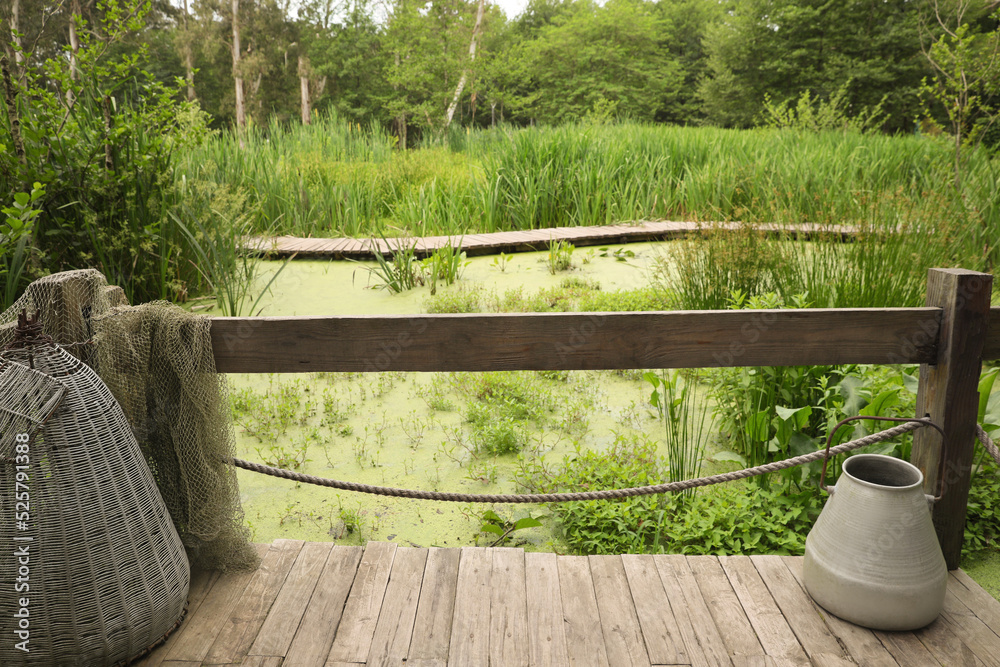 Beautiful wooden terrace with tin and fishing net near swamp Beautiful wooden terrace with tin and fishing net near swamp