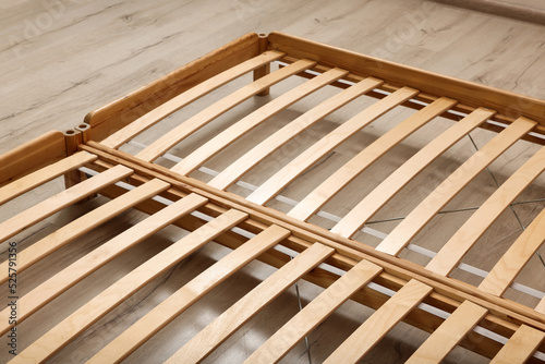 Wooden bed frame on floor  closeup view