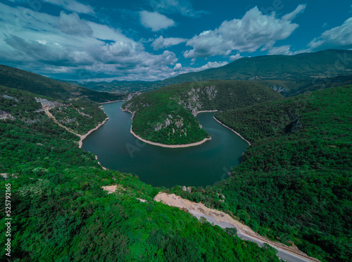 Curve or meander on river Vrbas, drone panorama, close to Banja Luka in bosnia and hercegovina on a sunny morning with puffyy clouds. photo