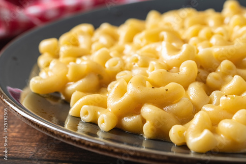 Delicious Mac n Cheese or macaroni and cheese on a black porcelain plate photo