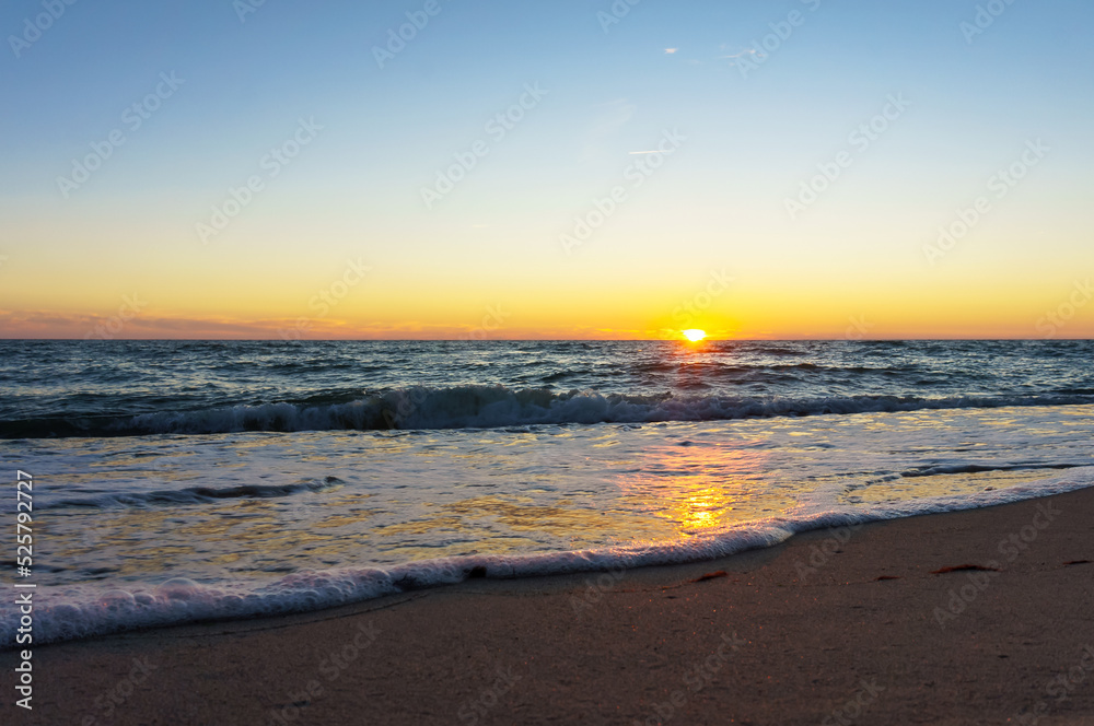 Sunset over the sea. Reflection of sunlight in the sea waves. The sky in the sunset rays. Sunset over the sea. Reflection of sunlight in the sea waves. The sky in the sunset rays.