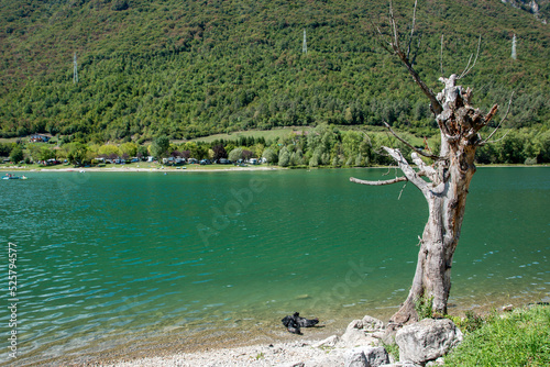 idro lake alpine water basin at the foot of the alpine peaks photo