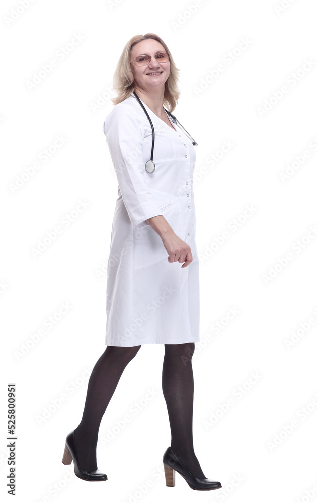 in full growth. smiling woman doctor striding confidently forward. in full growth. smiling woman doctor striding confidently forward.