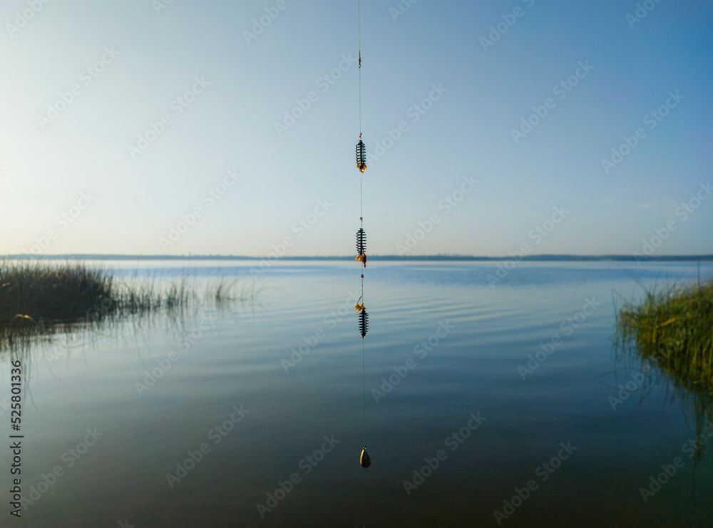 Fishing tackle for catching fish on the background of a blue lake