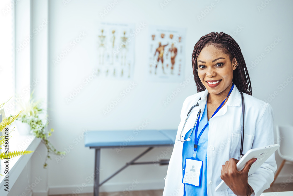Portrait of confident smiling female doctor. Mid adult medical professional is wearing lab coat and stethoscope. She is standing against gray wall in hospital. Portrait of confident smiling female doctor. Mid adult medical professional is wearing lab coat and stethoscope. She is standing against gray wall in hospital.