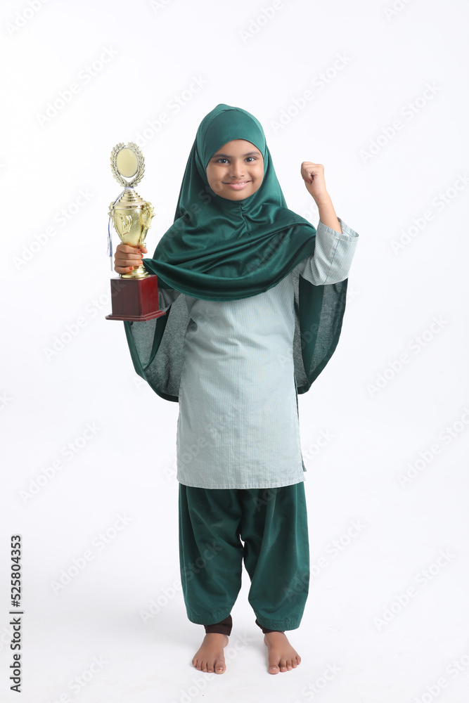 indian Muslim girl with hijab holding a winning trophy.
