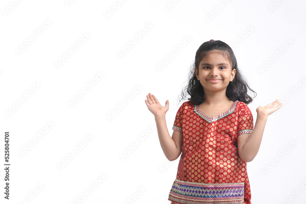 Indian little girl in traditional wear and giving expression on white background. Indian little girl in traditional wear and giving expression on white background.