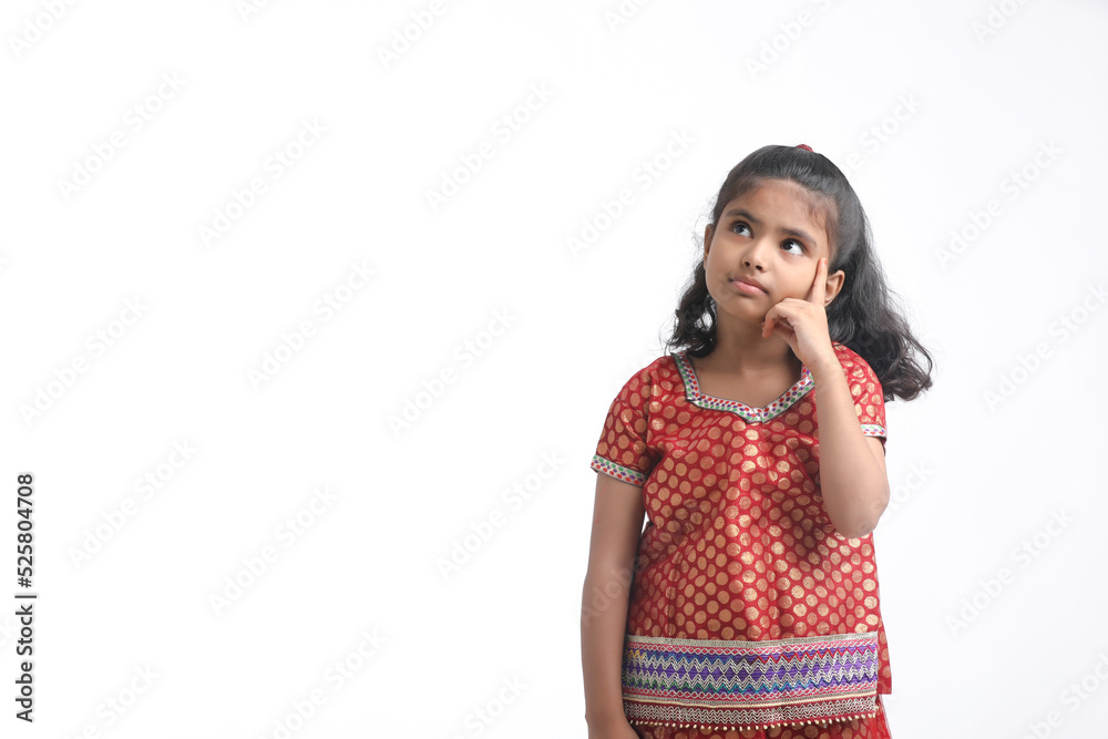 Indian little girl in traditional wear and giving expression on white background. Indian little girl in traditional wear and giving expression on white background.