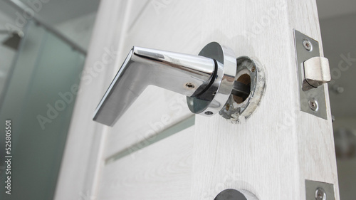 Broken doorknob in interior door. Poor quality door hardware, close-up