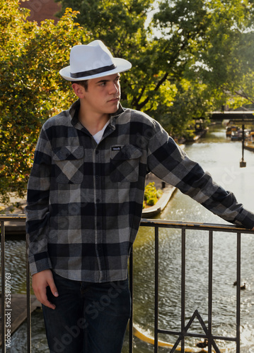 Stylish looking young man wearing a white hat.