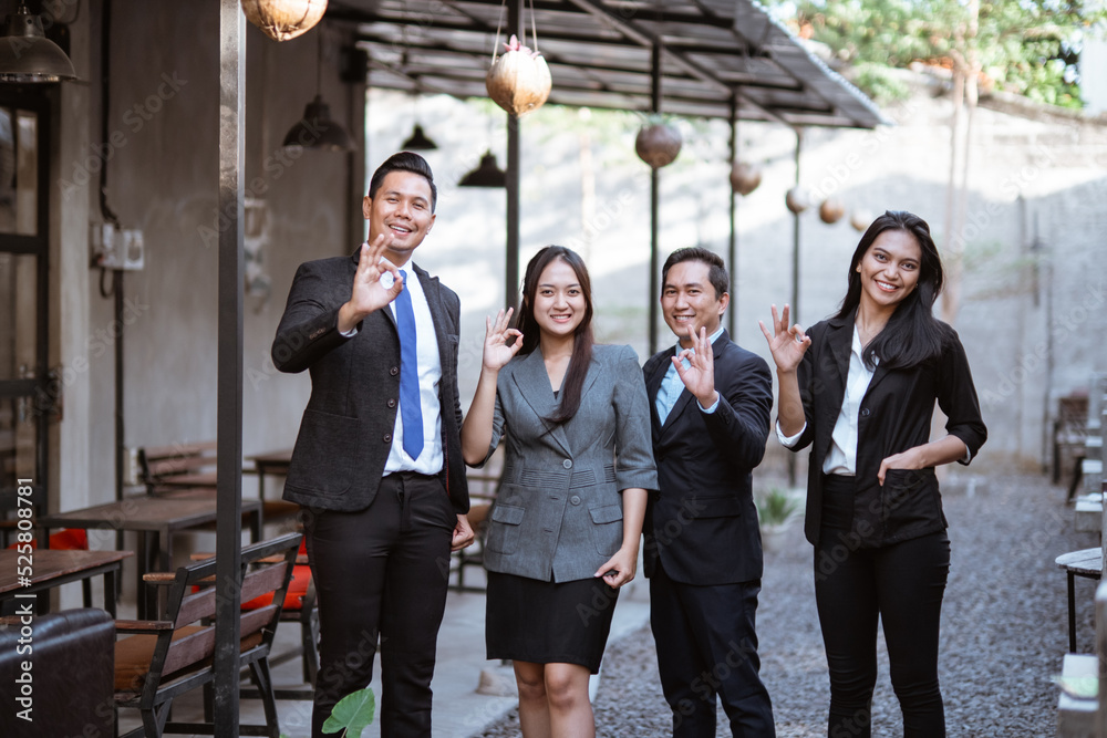 portrait asian business partner showing thumb up gesture to camera